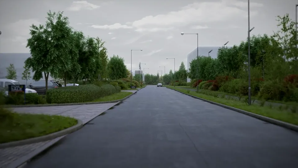 A business-park road sweeps between densely landscaped verges of hedges, shrubs and red-leaved planting, with metal-clad warehouse units beyond.