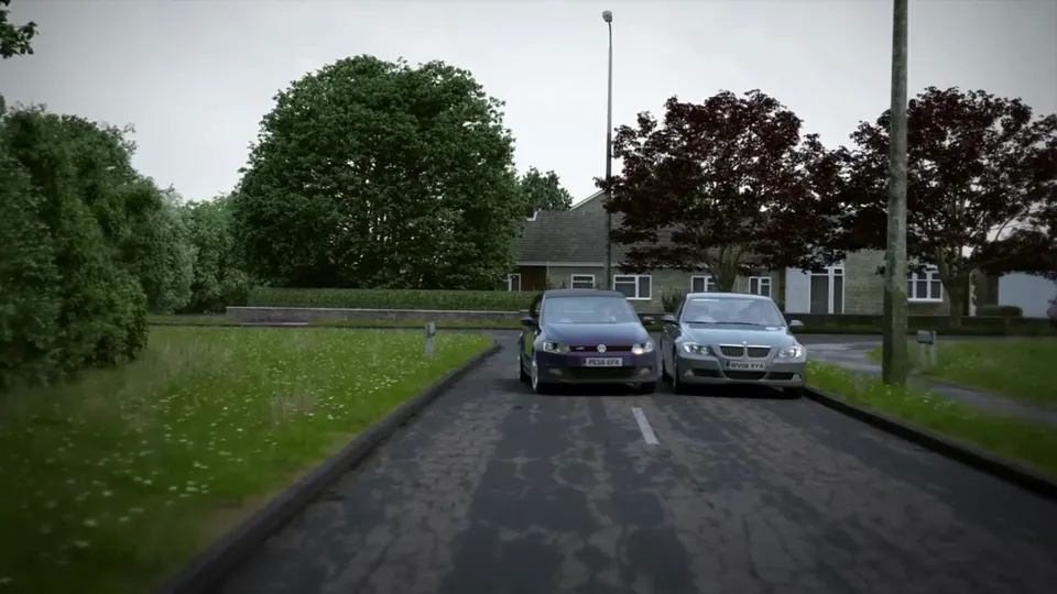 A curving tree-lined residential lane with grass verges and streetlamps opening into an estate of single-storey bungalows.