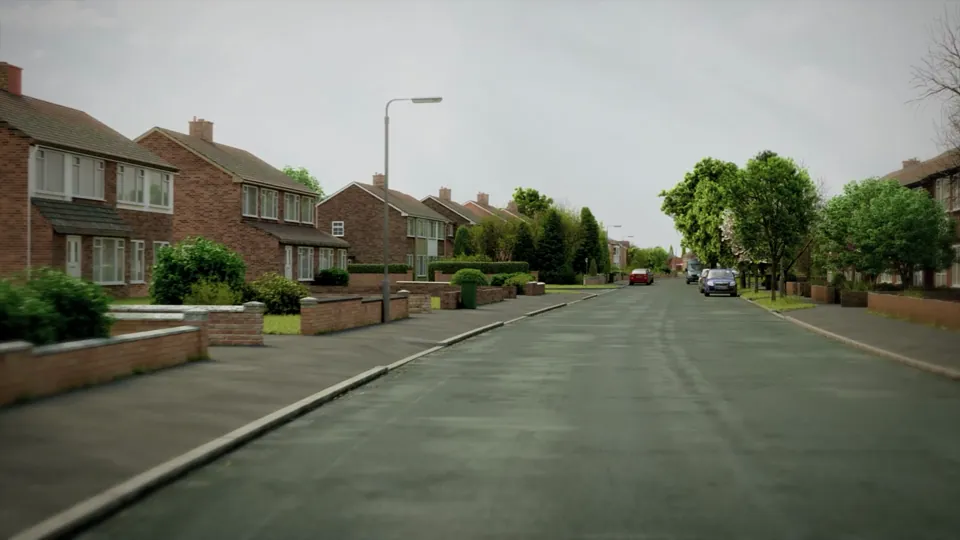 A suburban street of brick semi-detached houses with hedged front gardens, mature green trees and parked cars.