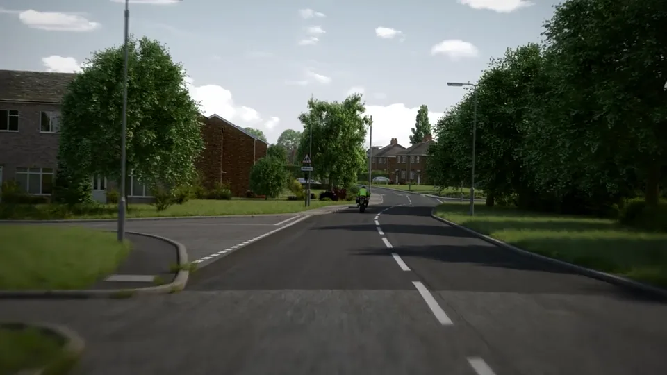 A sunlit suburban street with broad grass verges, mature trees and red-brick houses, a motorcyclist riding ahead in the distance.