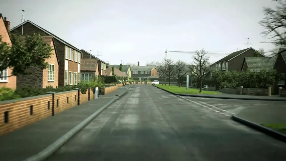 A quiet residential estate road past detached houses and bungalows with brick walls and hedges on a wet, grey day.