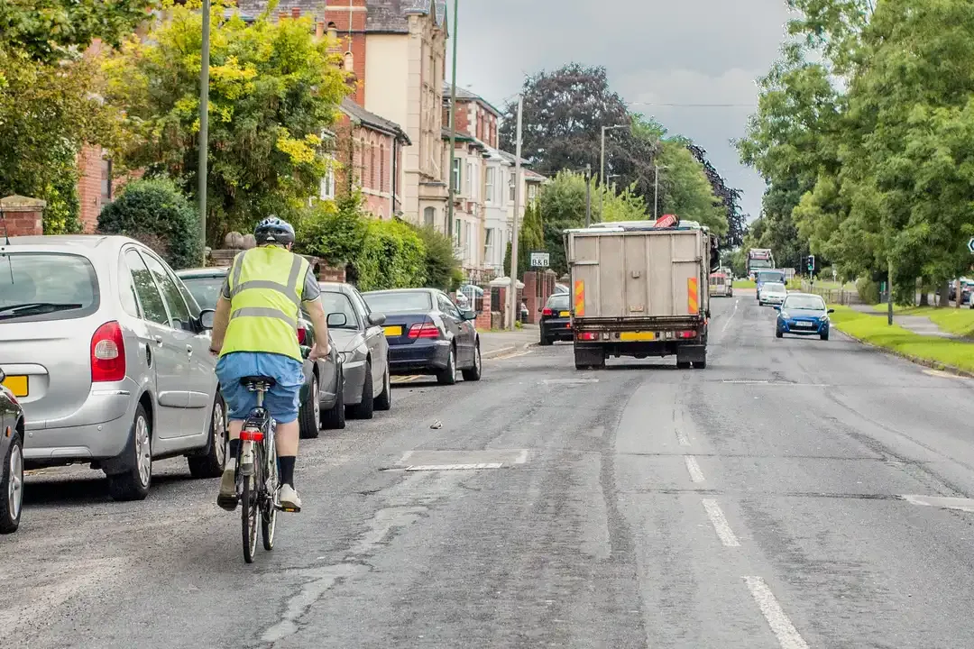 Illustration for the question: What's the main hazard you should be aware of when following this cyclist?