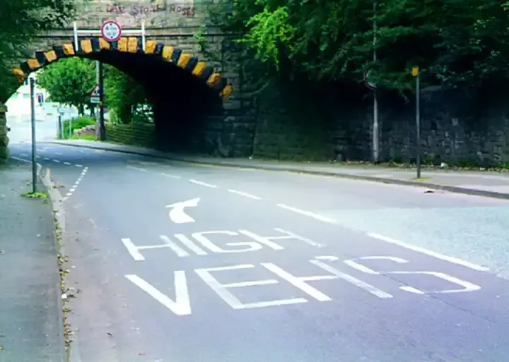 Illustration for the question: What should you do as you approach this overhead bridge?