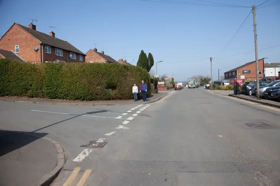 Illustration for the question: Your pupil’s driving in a town and wants to turn left into a junction. What should they do if pedestrians are waiting to cross at the junction?
