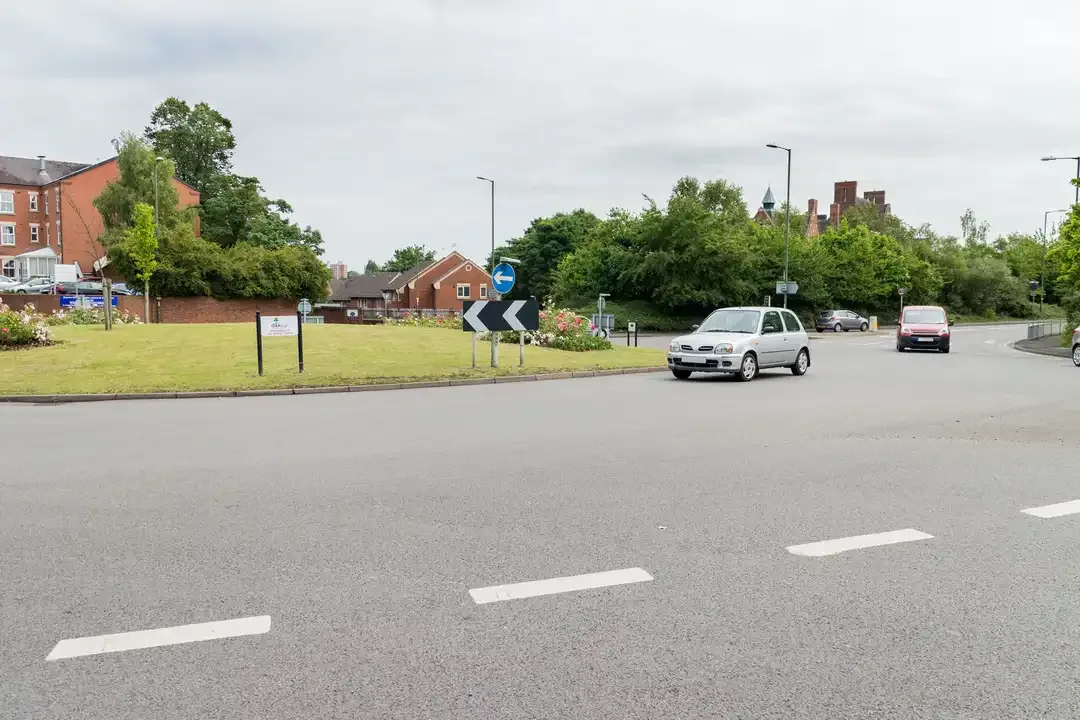 Illustration for the question: What does this line across the road at the entrance to a roundabout mean?