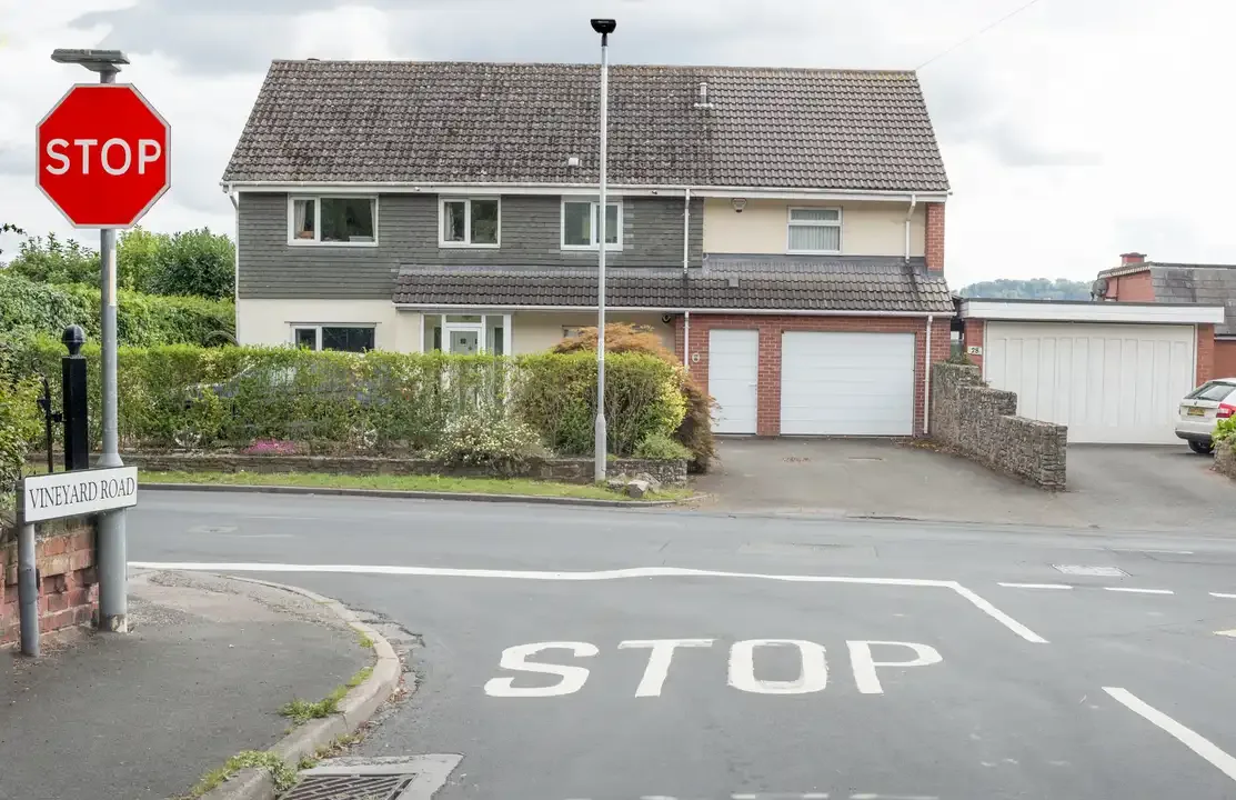 Illustration for the question: Why does this junction have a 'stop' sign and a stop line on the road?
